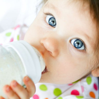 Should my baby hold their own bottle?