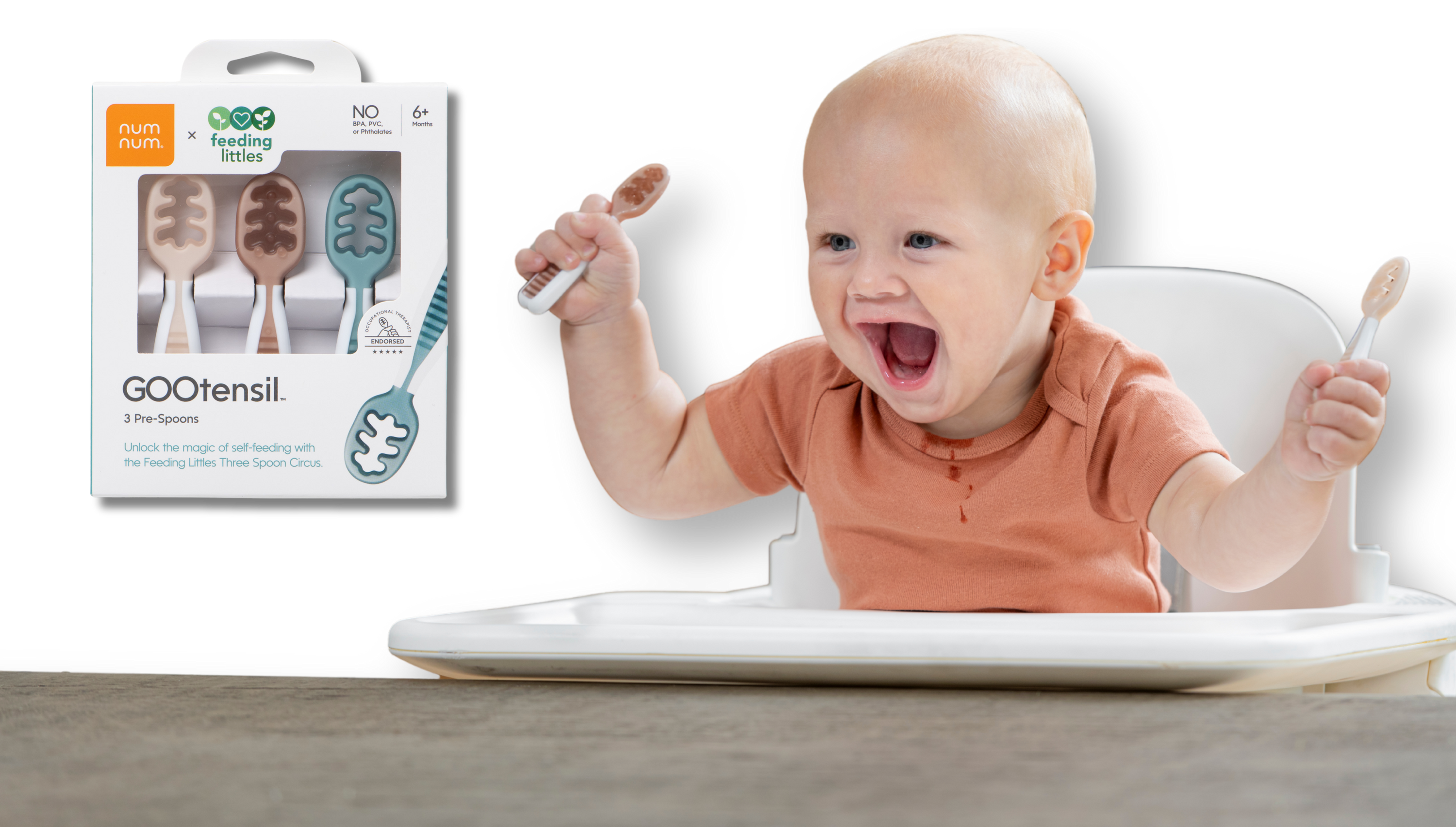 Baby in a high chair with GOOtensil spoons and packaging in the background