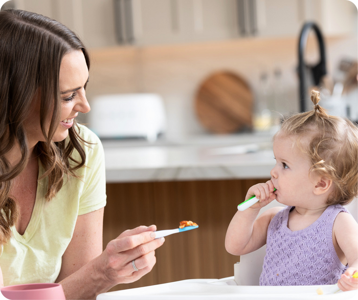woman feeding a baby